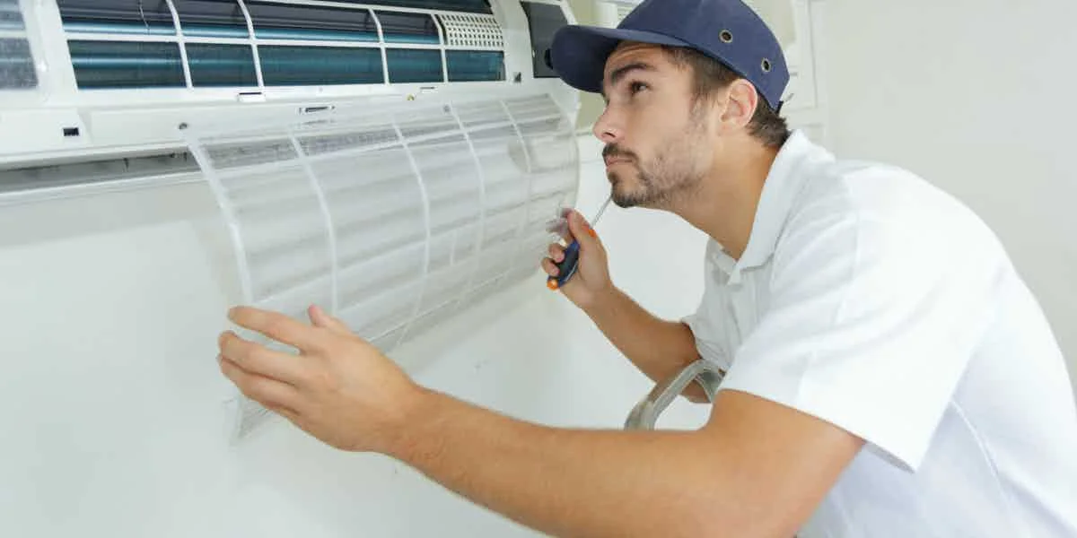 Technician performing air conditioning repair